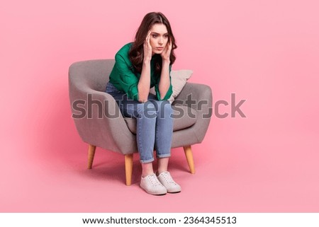 Full length photo of disappointed grumpy person sit soft chair hands touch temples empty space isolated on pink color background