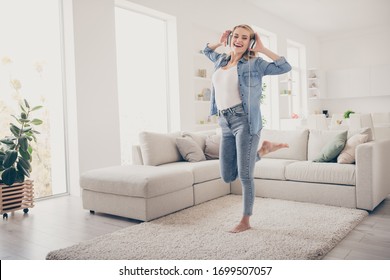 Full Length Photo Of Domestic Pretty Blond Lady Relaxing Dancing Near Couch Stay Home Listen Cool Earphones Favorite Song Quarantine Time Living Room Indoors