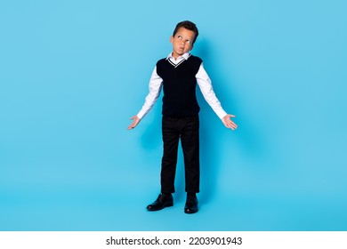 Full Length Photo Of Doubtful Unsure Little Guy Dressed Black Vest Shrugging Shoulders Looking Empty Space Isolated Blue Color Background