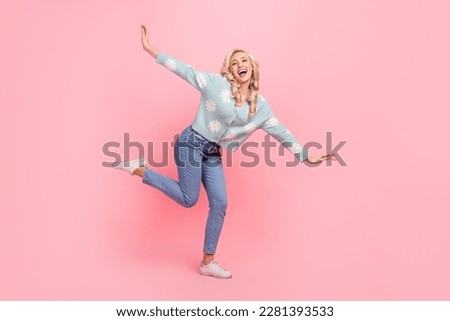 Full length photo of dreamy excited lady dressed flower print cardigan dancing flying arms sides isolated pink color background
