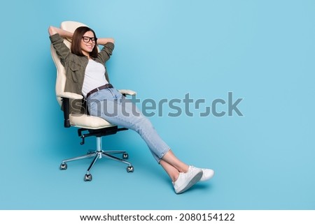 Full length photo of dreamy lady sit chair sleep hands over head wear khaki grey clothes isolated over blue color background
