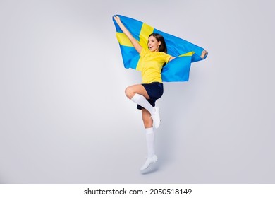 Full Length Photo Energetic Girl Soccer Sport Fan Hold Swedish Flag Support Country Team Enjoy Score Goal Win First Time Jump Wear Football Kit White Socks Boots Isolated Grey Color Background