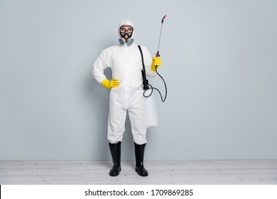 Full length photo of epidemic professional guy disinfectant start cleaning surface public places during pandemic hold sprayer wear white hazmat protective suit isolated grey color background - Shutterstock ID 1709869285