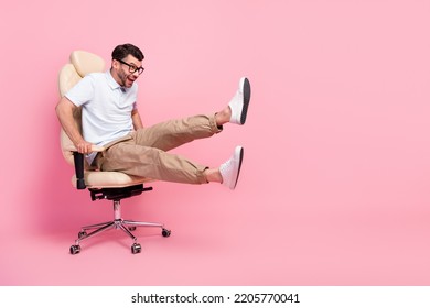 Full length photo of excited guy look copyspace fast ride chair game isolated on pastel color background