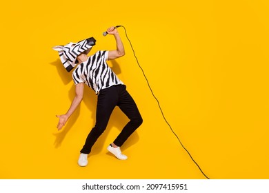 Full length photo of freak famous singer in zebra mask sing mic sound isolated over bright yellow color background