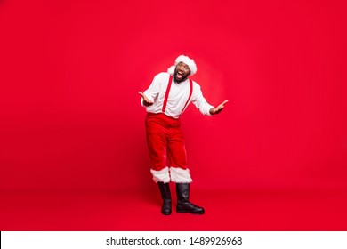 Full length photo of  funky hipster afro american santa having xmas cap screaming wearing pants trousers isolated over red background - Powered by Shutterstock