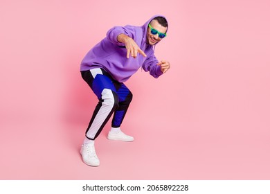 Full Length Photo Of Funky Young Brunet Guy Dance Wear Eyewear Hoodie Pants Shoes Isolated On Pink Background