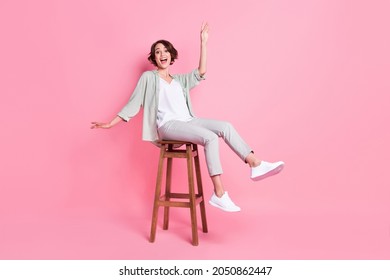 Full length photo of funny bob hairdo millennial lady sit dance wear grey green look isolated on pink background - Shutterstock ID 2050862447
