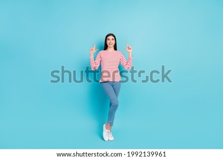 Full length photo of funny brunette hairdo young lady point look empty space wear red shirt jeans isolated on blue color background