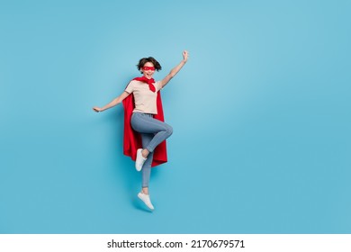 Full Length Photo Of Funny Cute Lady Dressed Red Mantle Jumping High Empty Space Isolated Blue Color Background