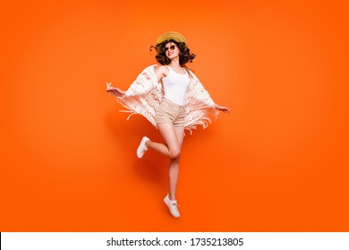 Full Length Photo Of Funny Lady Summer Time Jumping High Enjoy Great Resort Views Wear Stylish Sun Hat Specs Stylish White Lace Beach Cape Shorts Isolated Orange Background