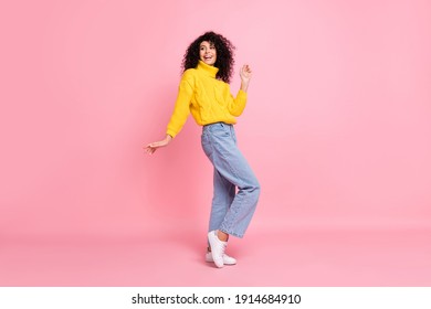 Full length photo of funny pretty wavy lady dressed yellow sweater dancing isolated pink color background - Powered by Shutterstock