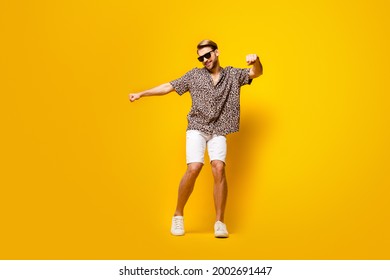 Full Length Photo Of Funny Sweet Young Guy Wear Leopard Outfit Dark Eyewear Smiling Dancing Isolated Yellow Color Background