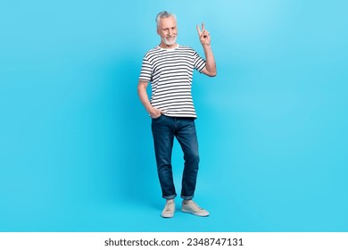 Full length photo of glad positive retired man dressed trendy outfit hand demonstrate v-sign isolated on blue color background