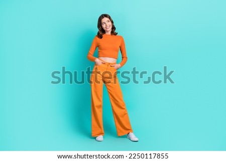 Full length photo of gorgeous pretty cheerful lady interested look empty space cool proposition isolated on cyan color background