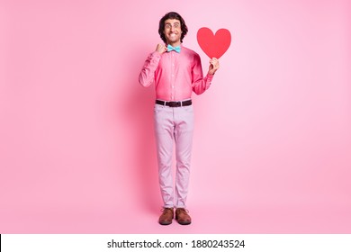 Full length photo of happy brunette charming young man hold red heart wear glasses isolated on pastel pink color background - Powered by Shutterstock