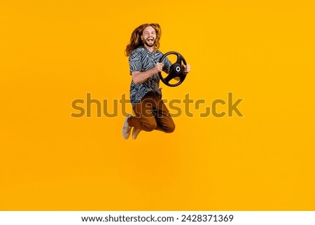 Full length photo of impressed excited guy wear print shirt jumping high riding car isolated yellow color background