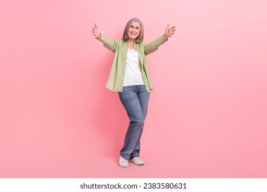 Full length photo of kind lovely friendly senior lady wear trendy clothes open arms glad see you isolated on pink color background - Powered by Shutterstock