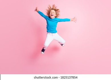 Full length photo of little child jump close eyes open mouth wear blue turtleneck trousers sneakers isolated pastel pink color background - Powered by Shutterstock