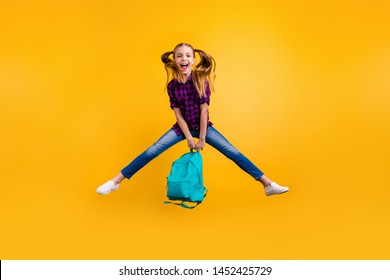 Full length photo of little pupil jump high finally holidays wear casual checkered shirt jeans denim isolated yellow background