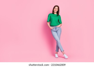 Full length photo of lovely young lady stand crossed legs shopping empty space wear stylish green garment isolated on pink color background - Shutterstock ID 2210462009