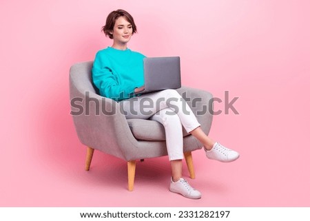 Full length photo of lovely young lady sit armchair work smm manager marketer wear trendy blue garment isolated on pink color background