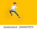 Full length photo of lucky strong boy wear white shirt jumping high enjoy karate empty space isolated yellow color background