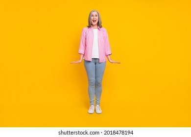 Full Length Photo Of Mature Woman Happy Positive Smile Amazed Surprised News Isolated Over Yellow Color Background