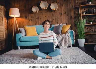 Full length photo of minded creative person sit floor use laptop brainstorming loft interior flat indoors - Powered by Shutterstock