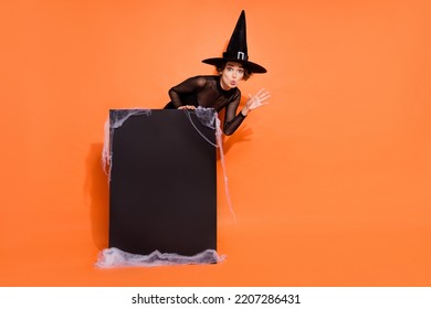 Full Length Photo Of Mystery Sorcerer Hand Terrifying Boo Empty Space Poster Isolated On Orange Color Background