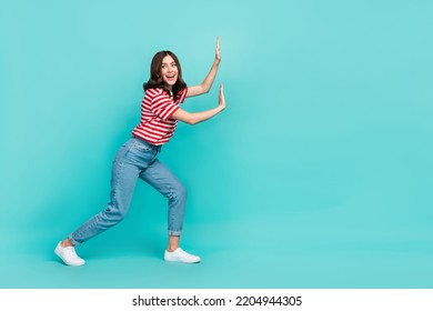 Full length photo of nice pretty lady hold carry touch empty space interested look promo isolated on aquamarine color background - Shutterstock ID 2204944305