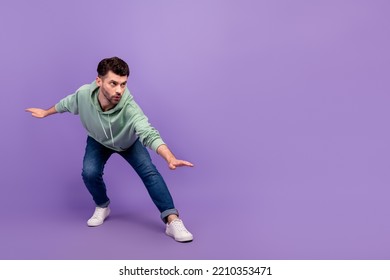 Full length photo of nice young man professional surfer focused banner promo dressed stylish khaki look isolated on purple color background - Powered by Shutterstock