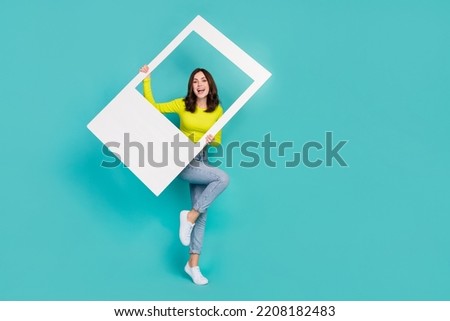 Full length photo of overjoyed energetic person hands hold paper album card isolated on aquamarine color background