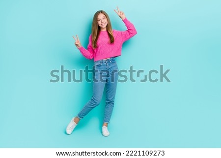Full length photo of overjoyed pretty lady wear trendy pink clothes arm demonstrate v-sign empty space isolated on cyan color background