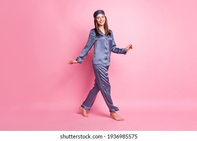 Full length photo portrait of girl walking isolated on pastel pink colored background