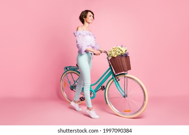 Full Length Photo Portrait Of Woman With Bycicle Walking Isolated On Pastel Pink Colored Background