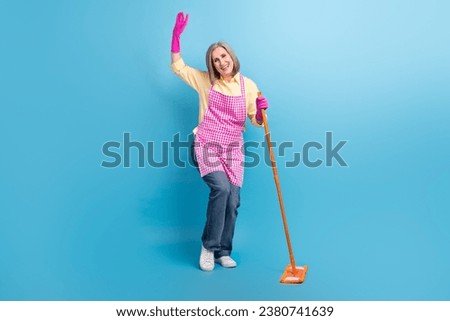 Full length photo of positive aged person hold mop wash floor childish dancing isolated on blue color background