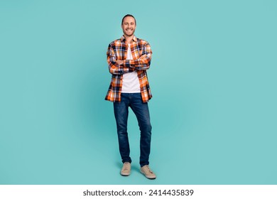 Full length photo of positive cheerful pleasant man wear flannel shirt jeans holding palms folded isolated on turquoise color background - Powered by Shutterstock