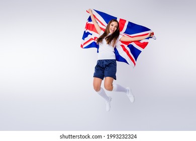 Full Length Photo Positive Energetic Girl Football Fan Enjoy Support National Team World Cup Championship Scream Jump Hold Uk Flag Wear T-shirt Shorts Socks Boots Isolated Grey Color Background