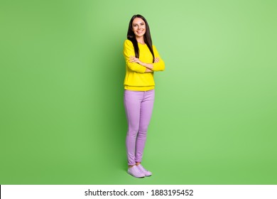 Full length photo of positive girl crossed arms toothy smile wear purple yellow isolated on green color background - Shutterstock ID 1883195452