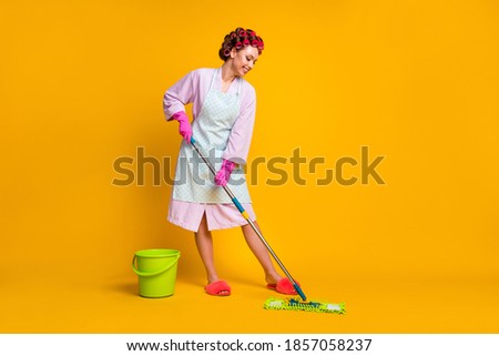 Full length photo of positive girl wash mop floor wear bath robe gloves isolated over bright color background