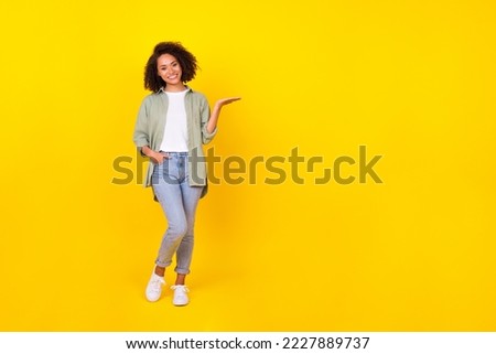 Full length photo of positive lady promoter hold hand demonstrate empty space promotion isolated vivid color background