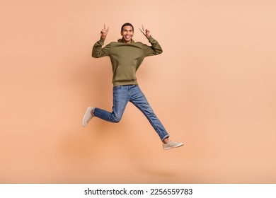 Full length photo of positive man wear stylish clothes hurrying shopping sale demonstrate v-sign symbol isolated on beige color background - Shutterstock ID 2256559783