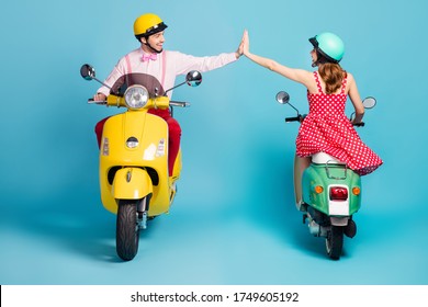 Full Length Photo Of Positive Two People Man Woman Ride Motor Bike Enjoy Fast Speed Race Success Team Work Hold Hand High Five Wear Formalwear Outfit Isolated Over Blue Color Background