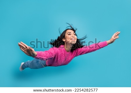 Full length photo of pretty adorable lady wear pink pullover arms sides falling air isolated blue color background