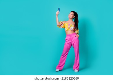 Full length photo of pretty cute girl dressed cropped top recording self video modern gadget empty space isolated teal color background - Shutterstock ID 2193120369