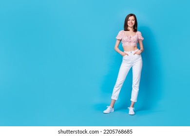 Full Length Photo Of Pretty Positive Lady Hand Arm Pocket Dressed Fashionable Outfit Stand Empty Space Isolated On Blue Color Background