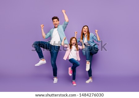 Full length photo of rejoicing dad mom and little foxy lady cool win wear casual clothes isolated purple background