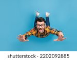 Full length photo of satisfied glad person toothy smile fall flying isolated on blue color background
