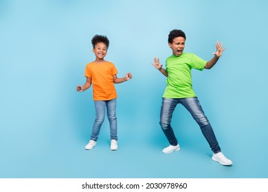 Full length photo of small funny brunet boy girl dance wear t-shirt jeans shoes isolated on blue color background - Powered by Shutterstock